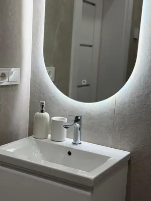 a bathroom with a sink and a mirror at Modern apartment near old town in Kaunas