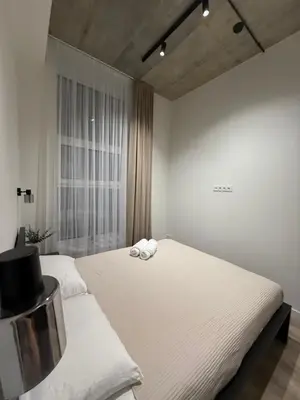a bedroom with a bed with two towels on it at Modern apartment near old town in Kaunas
