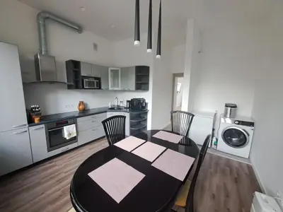 a kitchen and dining room with a table and chairs at Cathedral View Central Flat in Kaunas