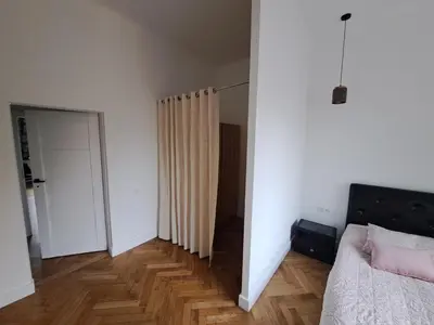 a bedroom with a bed and a hallway with a mirror at Cathedral View Central Flat in Kaunas