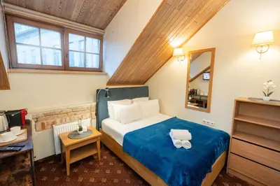 a hotel room with a bed and a mirror at OLD TOWN MARKET STAY , Self Check-in in Vilnius