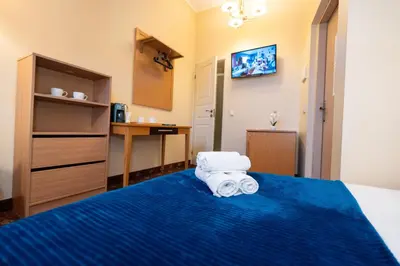 a hotel room with a bed with towels on it at OLD TOWN MARKET STAY , Self Check-in in Vilnius