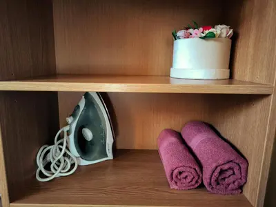 a wooden shelf with purple towels and a speaker at OLD TOWN MARKET STAY , Self Check-in in Vilnius