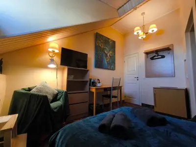 a bedroom with a bed and a desk with a computer at OLD TOWN MARKET STAY , Self Check-in in Vilnius