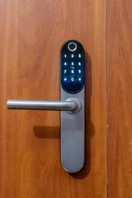 a remote control is attached to a wooden door at ENZO Apartments in Šiauliai
