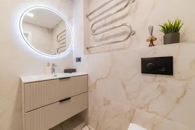 a bathroom with a sink and a mirror at ENZO Apartments in Šiauliai