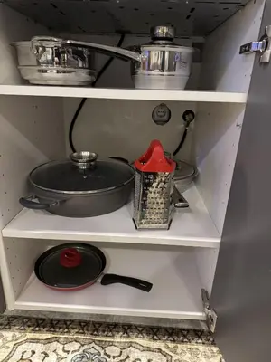 a shelf with a pot and a pan on it at Gates of Dawn luxury Apartment - Aušros Vartų apartamentai in Vilnius