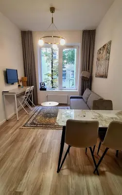 a living room with a table and a couch at Stay in Kaunas LA51A Standard - Free Parking in Kaunas