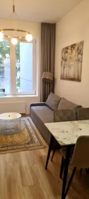 a living room with a couch and a table at Stay in Kaunas LA51A Standard - Free Parking in Kaunas