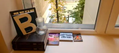 a window with books and a vase on a table at Stay in Kaunas LA51A Standard - Free Parking in Kaunas