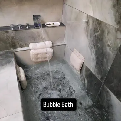a bathroom with a bubbler bathtub with two towels at K Spot in Old Town with Sauna and Jakuzzi in Vilnius