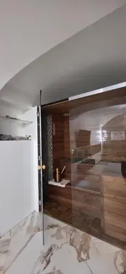 a bathroom with a glass shower with a sink at K Spot in Old Town with Sauna and Jakuzzi in Vilnius