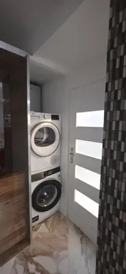 a bathroom with a washer and dryer in a room at K Spot in Old Town with Sauna and Jakuzzi in Vilnius