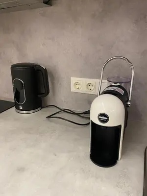 a coffee maker and a toaster sitting on a counter at Center Apartment near Hillton with self check-in in Vilnius