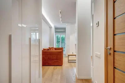 a hallway with a living room with a couch at Center Apartment near Hillton with self check-in in Vilnius