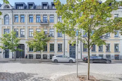 a white car parked in front of a building at Center Apartment near Hillton with self check-in in Vilnius
