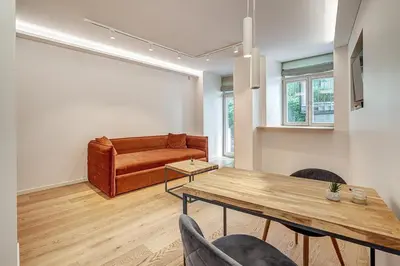 a living room with a couch and a table at Center Apartment near Hillton with self check-in in Vilnius