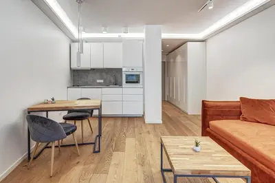 a living room with a couch and a table at Center Apartment near Hillton with self check-in in Vilnius