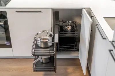 a kitchen with two pots and pans on a shelf at 2 Bedroom Green City View apartment by Reside Baltic in Vilnius
