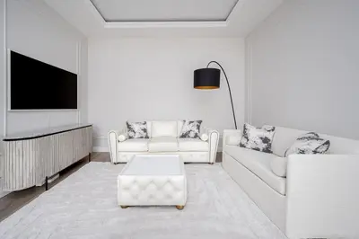 a living room with two white couches and a tv at Luxury apartment Gedimino Pr Downtown with parking in Vilnius