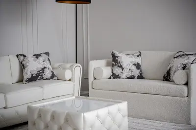 a living room with two couches and a coffee table at Luxury apartment Gedimino Pr Downtown with parking in Vilnius