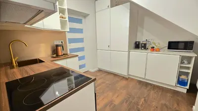 a kitchen with white cabinets and a sink at Centre Modern Elegance Apartment in Kaunas 2026 fully renovated in Kaunas