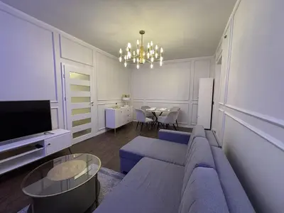 a living room with a blue couch and a table at Centre Modern Elegance Apartment in Kaunas 2026 fully renovated in Kaunas