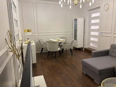 a living room with a table and a couch at Centre Modern Elegance Apartment in Kaunas 2026 fully renovated in Kaunas