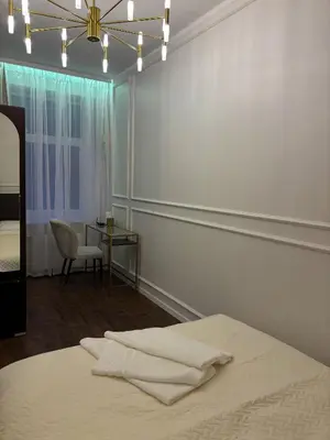 a bedroom with a bed and a table with a chair at Centre Modern Elegance Apartment in Kaunas 2026 fully renovated in Kaunas