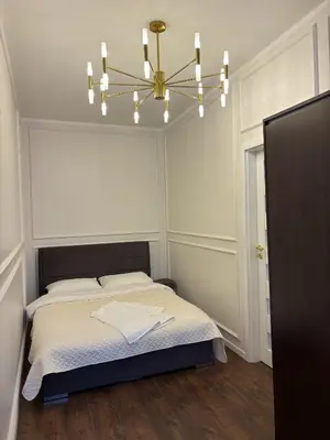 a bedroom with a bed and a chandelier at Centre Modern Elegance Apartment in Kaunas 2026 fully renovated in Kaunas