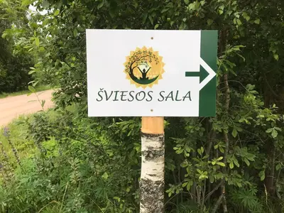 a sign that saysyssos saale on a tree at namelis tyloje in Šarkiškės