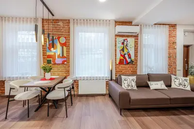 a living room with a couch and a table at Center Gallery Apartment in Kaunas