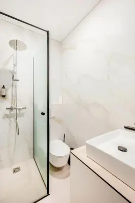 a bathroom with a shower and a toilet and a sink at Center Gallery Apartment in Kaunas