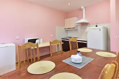 a kitchen and dining room with a table and chairs at Leokordis, UAB in Rokiškis
