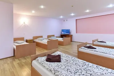 a room with several beds and a projection screen at Leokordis, UAB in Rokiškis