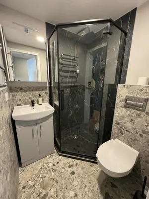a bathroom with a shower and a toilet and a sink at Trumpalaikė butų nuoma Kaune prie Klinikų STUDIJA E SELF CHECK IN in Kaunas