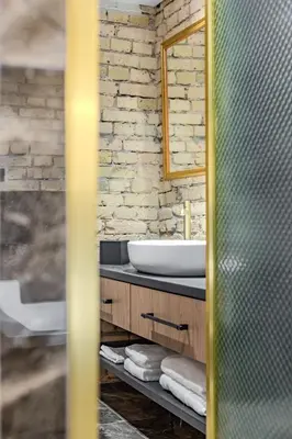 a bathroom with a sink and a mirror at Basanavičiaus apartament in Vilnius