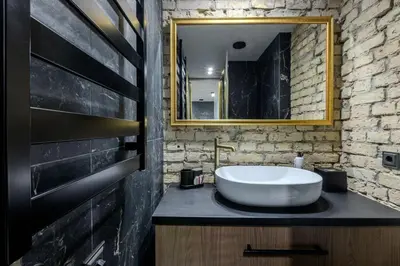 a bathroom with a white sink and a mirror at Basanavičiaus apartament in Vilnius