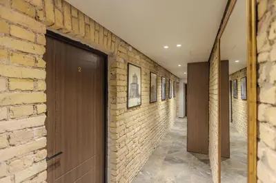 a hallway with a brick wall and a door at Basanavičiaus apartament in Vilnius