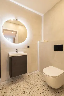 a bathroom with a toilet and a sink and a mirror at City Rooms by Lollo Stay in Vilnius