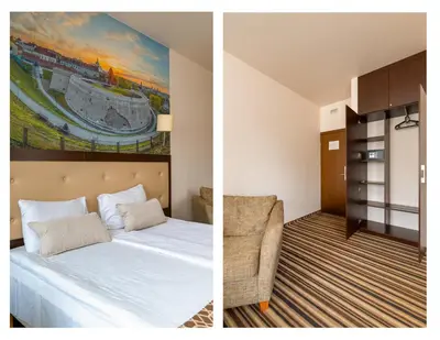 a hotel room with a bed and a painting of a stadium at City Rooms by Lollo Stay in Vilnius