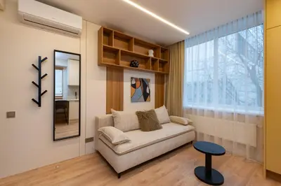 a living room with a couch and a window at City Rooms by Lollo Stay in Vilnius