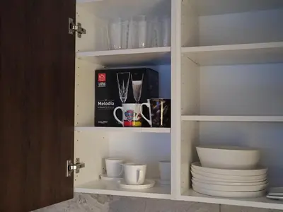 a cupboard filled with plates and cups and bowls at Manere commoda in Šiauliai