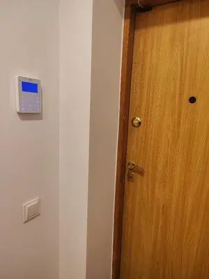 a door with a clock on the side of a room at Manere commoda in Šiauliai