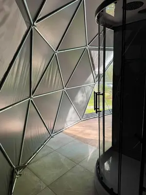 a glass walled room with a view of a patio at Tyla Dviese in Bendoriai