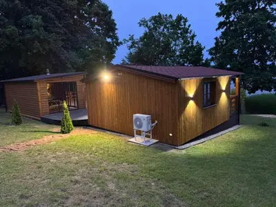 a small building with a speaker in a yard at Pasakų namelis in Svėdasai