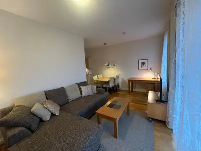 a living room with a couch and a table at V13 Apartment in Old Town in Vilnius
