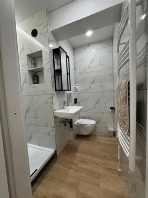 a bathroom with a sink and a toilet and a tub at Greenhill in Kaunas