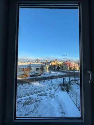 a window with a view of a snowy street at Greenhill in Kaunas