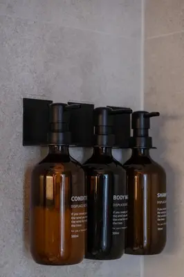 three bottles of soap sitting next to each other at Designer Penthouse with Huge Terrace & Fast Wi-Fi in Kaunas